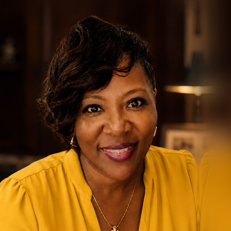 Audrey Bell-Kearney, founder of The Community Reboot, smiling in a yellow blouse